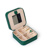 The GEM GLOW Jewelry Travel Case open with rings and earrings safely separated in different compartments for easy travel.
