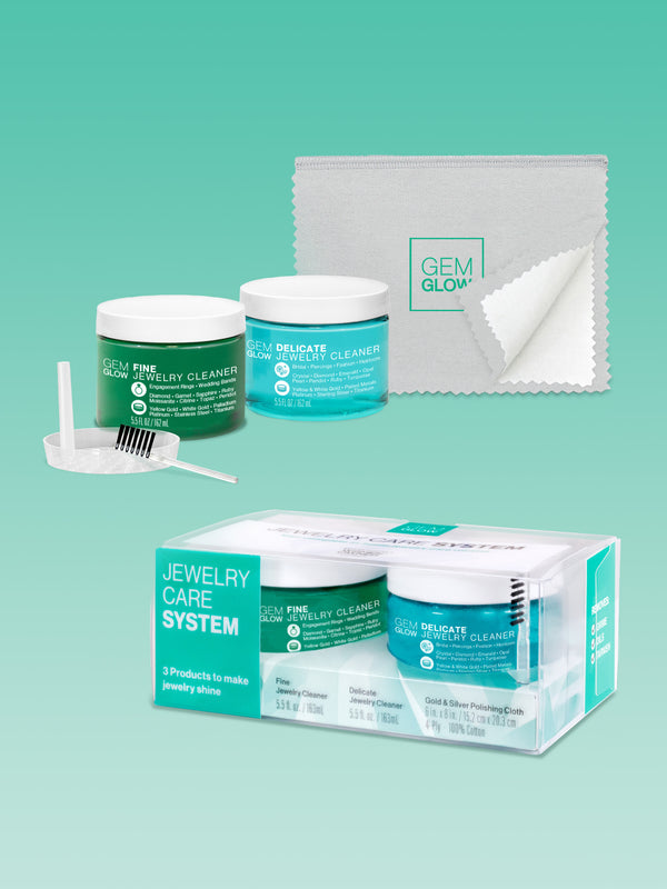 Outer packaging of the GEM GLOW Jewelry Care System, and the products included unpackaged.