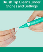 Hands using the Gem Glow Jewelry Cleaning Stick to clean in-between settings on a diamond ring.