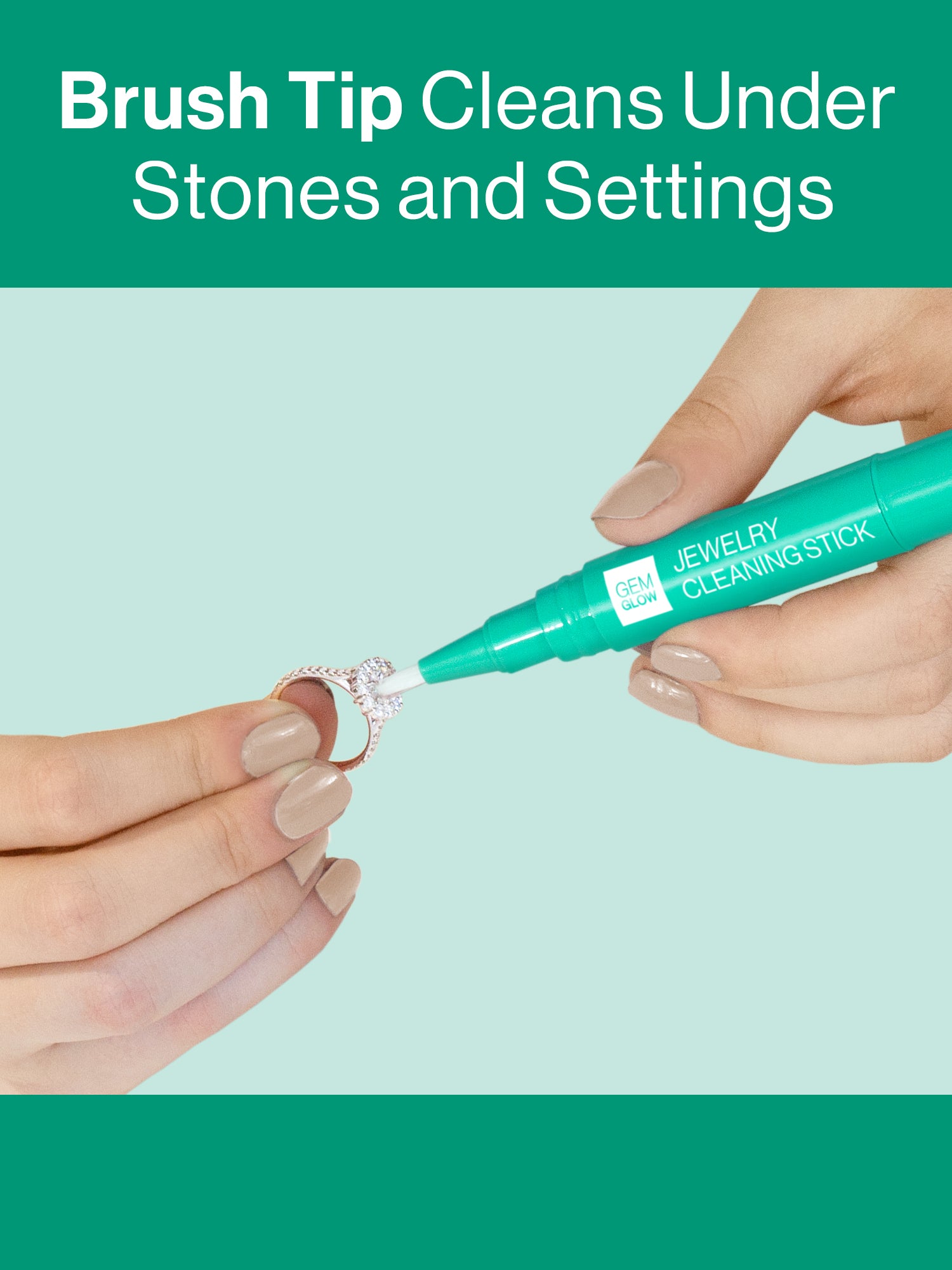 Hands using the Gem Glow Jewelry Cleaning Stick to clean in-between settings on a diamond ring.