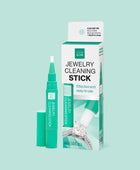 Outer packaging of the GEM GLOW Jewelry Cleaning Stick next to the Stick uncapped to display brush head.