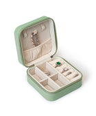 The GEM GLOW Jewelry Storage Case open with a necklace, bracelet and four rings secured inside the proper compartments.