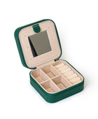 The GEM GLOW Jewelry Travel Case open, showing three sections with compartments that separate jewelry and a built-in mirror.