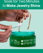 Hands using the included touch-up brush to clean a diamond bracelet after soaking in the GEM GLOW 7.5 oz. Fine Jewelry Cleaner.